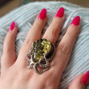 Large sliver ring with green Baltic amber